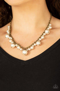 Paparazzi Uptown Pearls - Brass  -  Oversized white pearls featuring leafy brass fittings and a collection of bubbly white pearls swing from the bottom of an antiqued brass chain, creating a vintage inspired fringe below the collar. Features an adjustable clasp closure.
