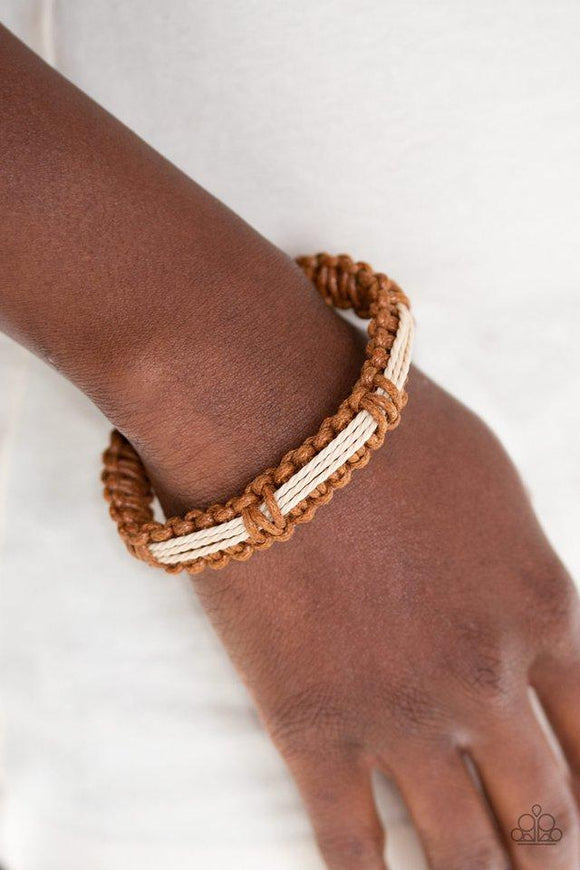 Paparazzi Urban Outing - Brown  -  Braided brown cording knots around earthy strands of twine-like cording, creating an urban look around the wrist. Features an adjustable sliding knot closure.
