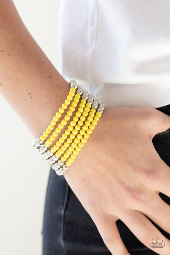 Paparazzi LAYER It On Thick - Yellow  -  Held together with silver fittings, row after row of ornate silver and polished yellow beads are threaded along stretchy bands around the wrist for a colorful fashion.
