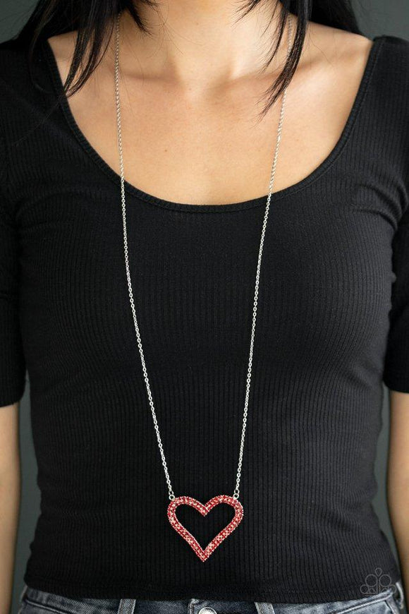 Paparazzi Pull Some HEART-strings - Red  -  Two rows of glittery red rhinestones stack into a sparkling heart pendant at the bottom of a lengthened silver chain for a heart-stopping look. Features an adjustable clasp closure.
