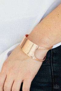 Paparazzi What GLEAMS Are Made Of - Copper - Bracelet
Stamped in a slanted linear pattern, a shiny copper cuff featuring an airy asymmetrical cutout wraps around the cuff for a bold industrial look. 
