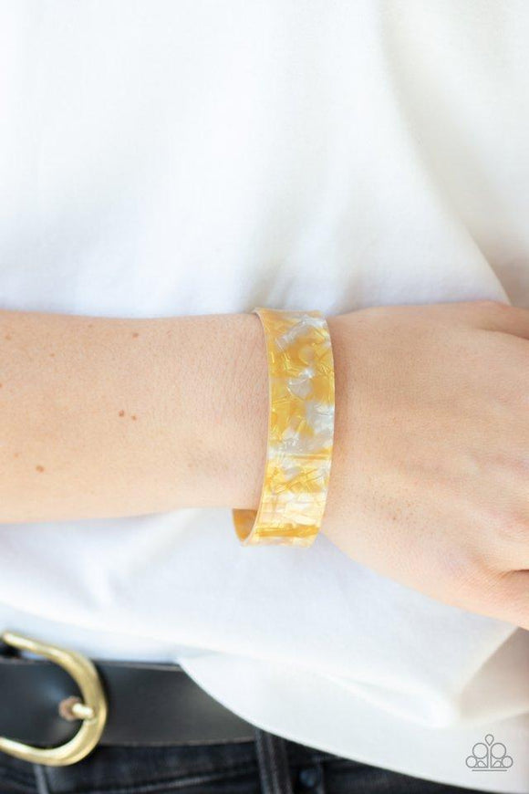 Paparazzi Glaze Daze - Yellow  -  Featuring an iridescent shimmer, a speckled yellow acrylic cuff waves across the wrist for a colorfully retro look.
