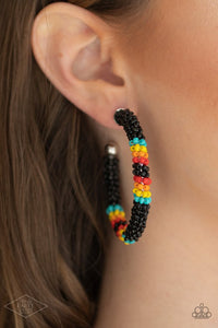 Paparazzi Bodaciously Beaded - Black - Earrings  -  A colorful strand of black, blue, yellow, orange, and red seed beads wraps around a shiny silver hoop, creating a colorfully seasonal look. Earring attaches to a standard post fitting. Hoop measures approximately 2" in diameter.