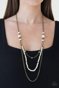 Paparazzi Very Vintage - Brass  -  A collection of white pearls and glassy white rhinestone encrusted rings give way to mismatched strands of brass chain and dainty pearls layering down the chest for a vintage inspired fashion. Features an adjustable clasp closure.
