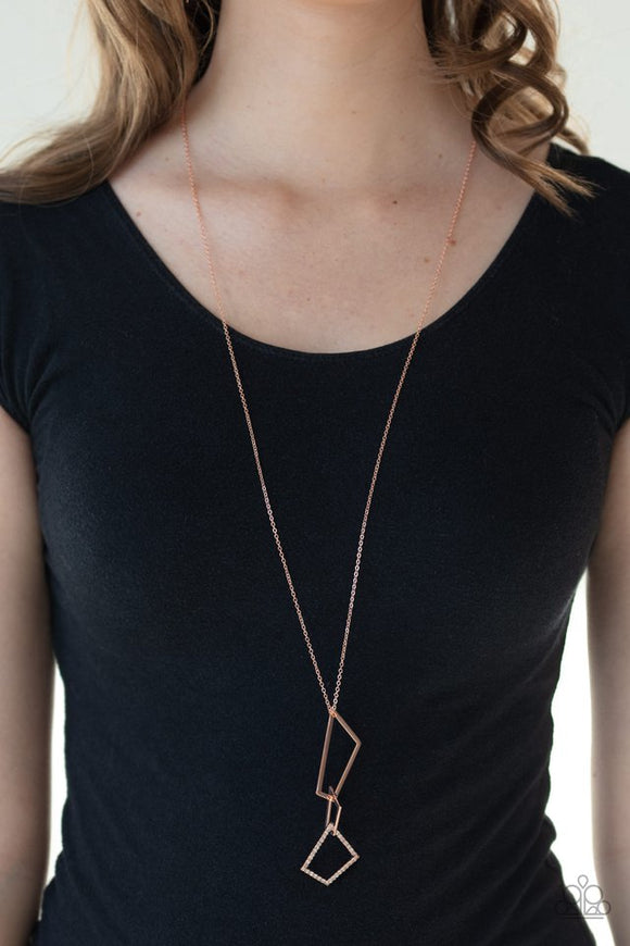 Paparazzi Shapely Silhouettes - Copper - Necklace  -  A mismatched collection of white rhinestone encrusted and shiny copper trapezoid frames connect at the bottom of a lengthened shiny copper chain, creating an abstract pendant. Features an adjustable clasp closure.

