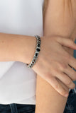 Paparazzi Caught In The Cross HEIRS - Black - Bracelet  -  Dotted with a black beaded and glassy rhinestone encrusted centerpiece, a crisscrossing silver bangle-like cuff slides along the wrist for a whimsical look. Features a hinged closure.
