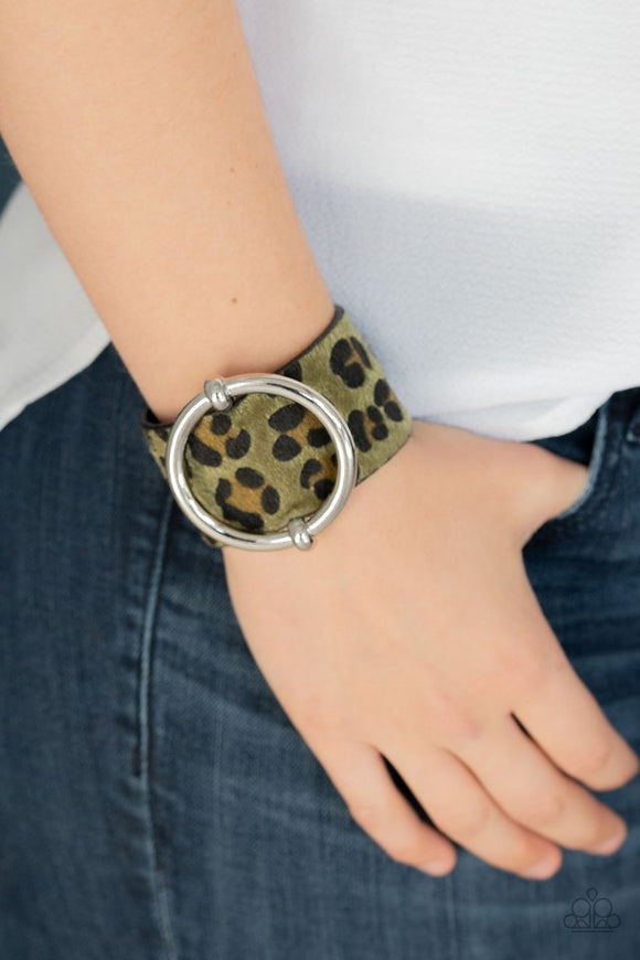 Paparazzi Asking FUR Trouble - Green - Bracelet  -  A dramatically oversized silver ring slides along a thick black leather band featuring fuzzy green cheetah print for a wild finish. Features an adjustable snap closure.
