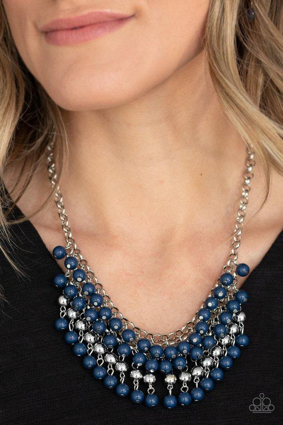 Paparazzi Jubilant Jingle - Blue  -  A colorful cascade of polished blue and shimmery silver beads dangle from interlocking silver chains, creating a stacked fringe below the collar. Features an adjustable clasp closure.
