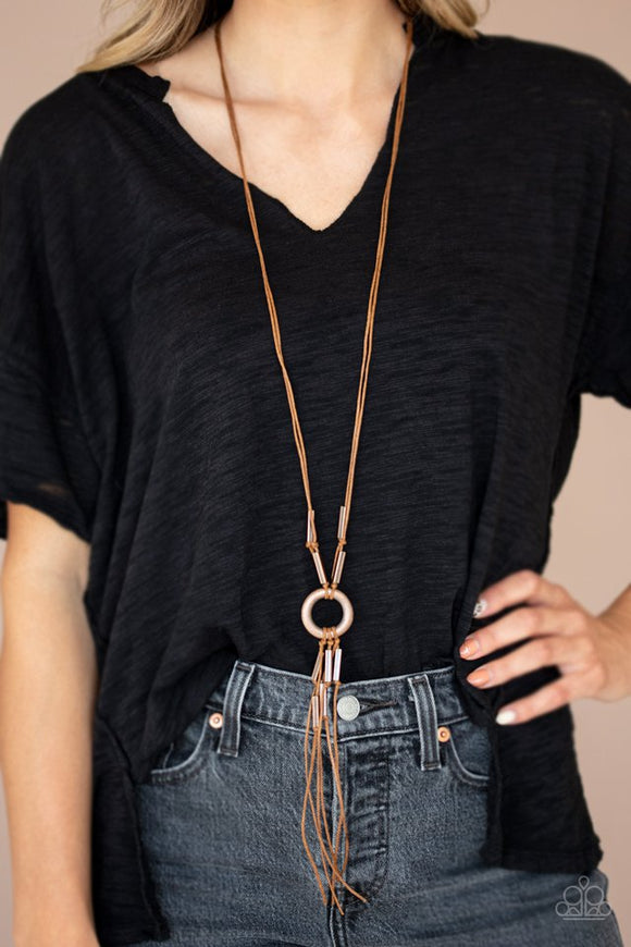 Paparazzi Tasseled Trinket - Copper - Necklace  -  Rectangular copper beads are knotted in place along strands of shiny brown cording, creating a rustic tassel at the bottom of an antiqued copper ring. Features an adjustable clasp closure.
