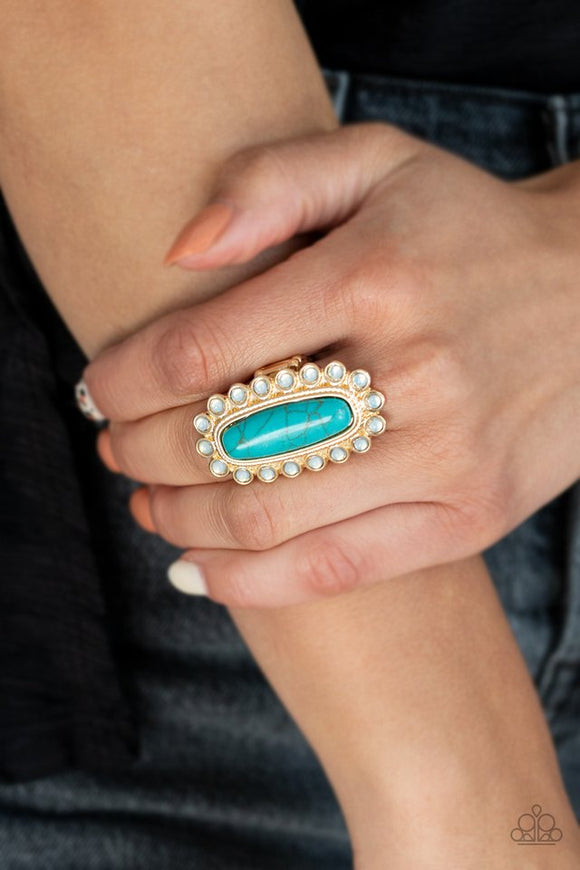 Paparazzi Mystic Oasis - Gold - Ring  -  Featuring a textured gold frame, an oversized oblong turquoise stone is bordered in dainty opalescent stone beads for an ethereal effect. Features a stretchy band for a flexible fit.
