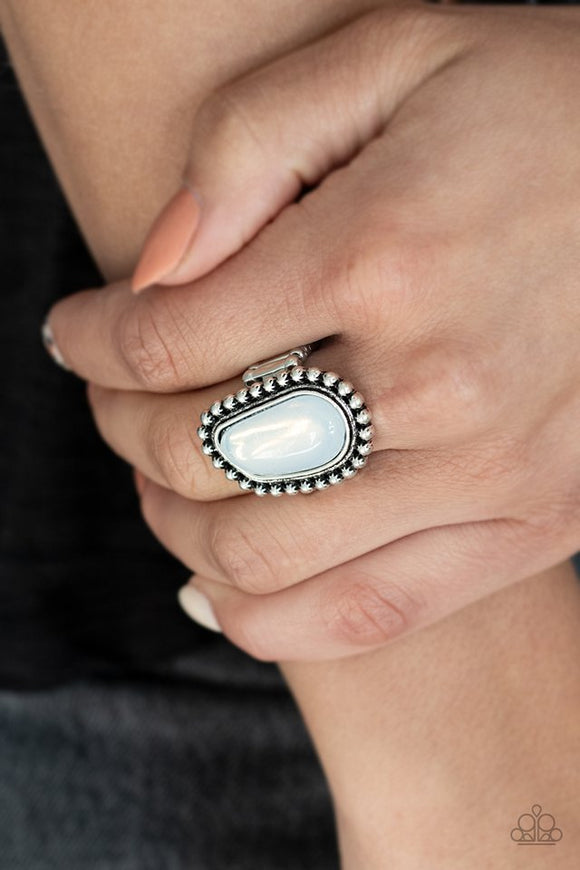 Paparazzi For ETHEREAL! - White - Ring  -  An asymmetrical opalescent stone is pressed into the center of a studded silver frame, creating an ethereal centerpiece atop the finger. Features a stretchy band for a flexible fit.
