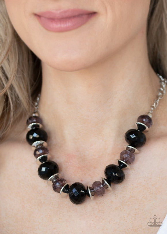 Paparazzi Hollywood Gossip - Black - Necklace  -  Saucer shaped silver beads trickle between faceted black beads and smoky crystal-like beads along an invisible wire, creating a glamorous display below the collar. Features an adjustable clasp closure.
