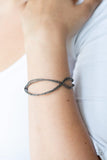Paparazzi Bending Over Backwards - Black - Bracelet  -  Featuring diamond-cut texture, dainty gunmetal bars delicately crisscross over and around the wrist, coalescing into an airy cuff.
