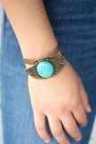 Paparazzi Desert Nature - Brass - Bracelet  -  A round turquoise stone is pressed into the center of a brass frame etched and embossed in whimsical floral detail, creating a seasonal centerpiece atop a thick brass cuff.
