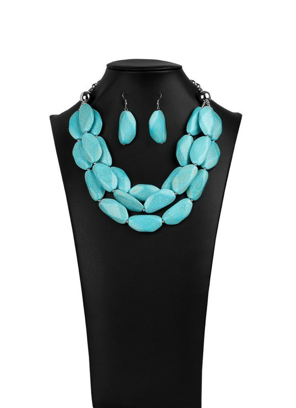 Paparazzi Authentic - 2020 Zi Signature Collection  -  Three groundbreaking tiers of faceted turquoise stones and dainty silver beads layer down the chest, creating bold layers. The earthy stones combine flawlessly with strands of silver chain, pioneering the way for the trendsetters everywhere. Features an adjustable clasp closure.
