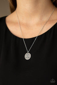 Paparazzi America The Beautiful - Silver  -  Stamped in the patriotic phrase, "America The Beautiful," a shiny silver disc slides along a dainty silver chain below the collar for a whimsical look. Features an adjustable clasp closure.

