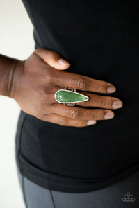 Paparazzi Spiritual Awakening - Green - Ring  -  An elongated green stone teardrop is pressed into a sleek silver frame atop the finger, creating a mystical centerpiece. Features a dainty stretchy band for a flexible fit.
