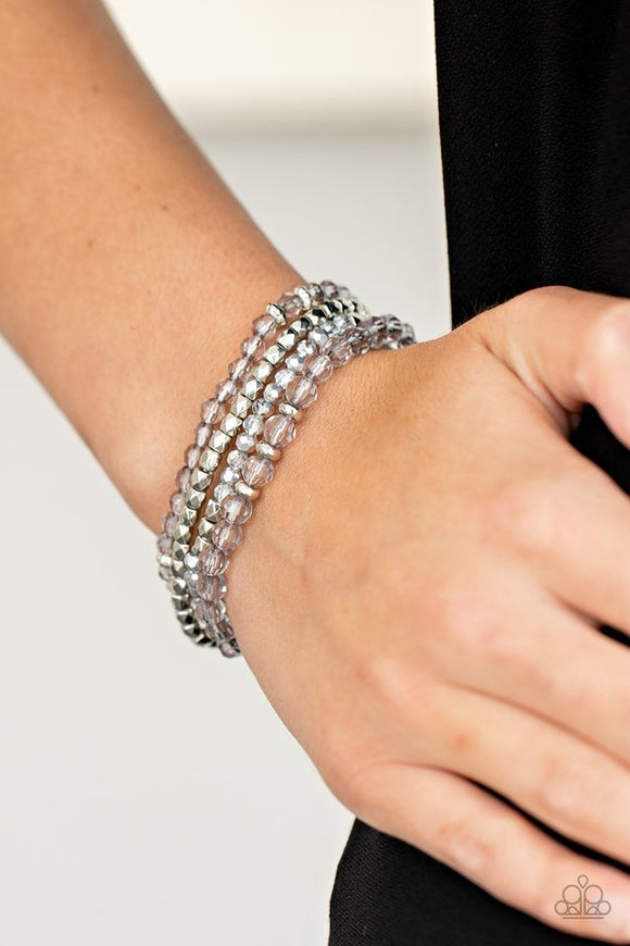 Paparazzi Crystal Crush - Silver - Bracelet  -  A glittery collection of faceted silver beads and smoky and metallic flecked crystal-like beads are threaded along stretchy bands around the wrist, creating sparkly layers.
