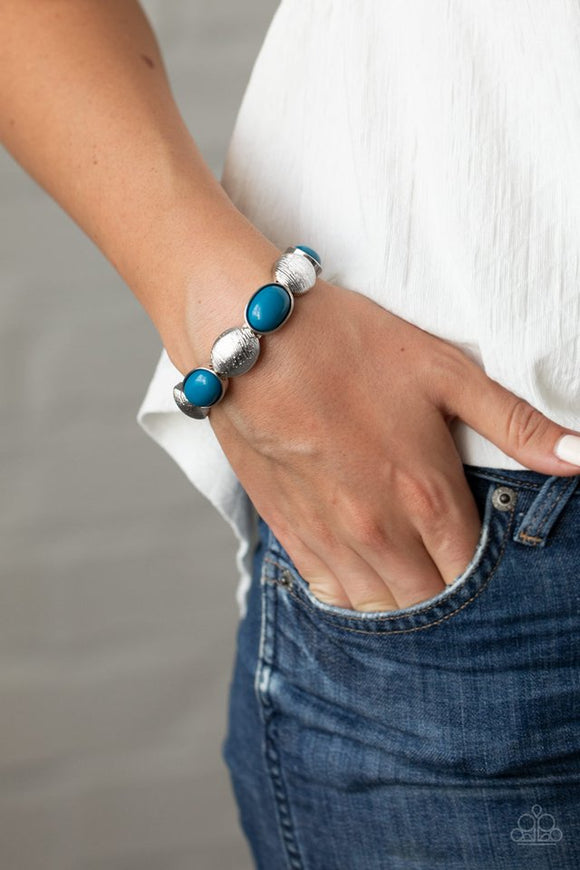 Paparazzi Decadently Dewy - Blue - Bracelet  -  Bubbly blue beaded frames and textured silver caps alternate along stretchy bands around the wrist, adding a colorful pop of color.
