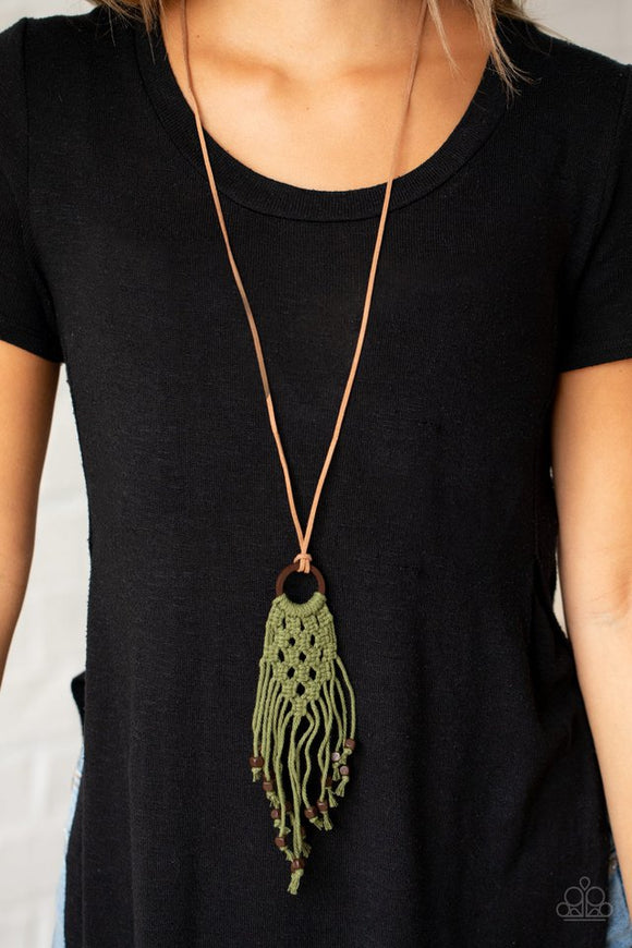 Paparazzi Its Beyond MACRAME! - Green - Necklace  -  Square wooden beads are knotted at the ends of green twine-like cording that braids and weaves around a wooden hoop, creating an earthy macram pendant at the bottom of a dainty piece of brown suede. Features an adjustable knotted closure.
