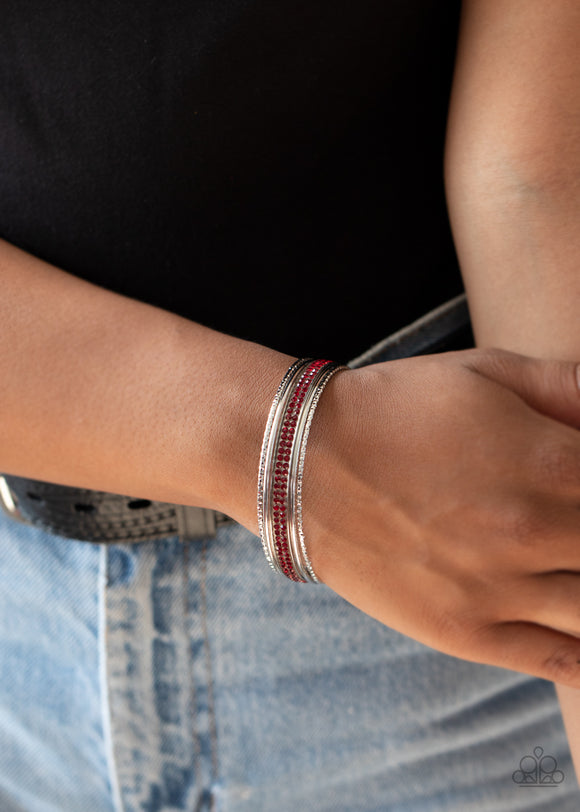 Paparazzi Heap It On - Red - Bracelet  -  Pairs of smooth and hammered silver bangles join a red rhinestone encrusted bracelet around the wrist, creating an edgy stack of sparkle.  

    


