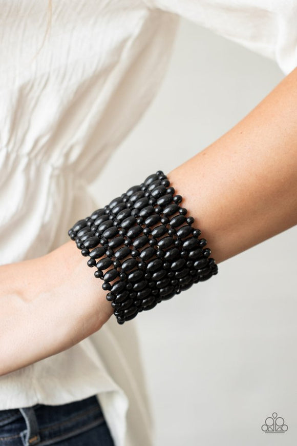 Paparazzi Way Down In Kokomo - Black - Bracelet  -  Round and oval black wooden beads are threaded along stretchy bands that intricately weave around the wrist, coalescing into a colorful stretch bracelet.
