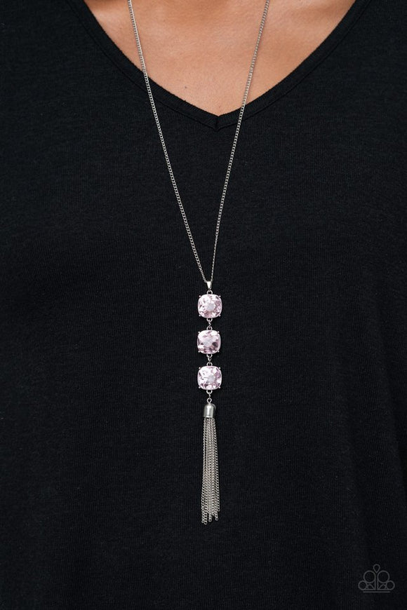 Paparazzi GLOW Me The Money! - Pink - Necklace  -  Nestled inside studded silver fittings, a trio of glittery pink gems gives way to a shimmery silver chain tassel, creating a refined pendant. Features an adjustable clasp closure.
