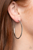 Paparazzi Spitfire - Silver - Earrings  -  Featuring flattened sections, a textured silver hoop boldly curls around the ear for an edgy flair. Earring attaches to a standard post fitting. Hoop measures approximately 1 3/4" in diameter.
