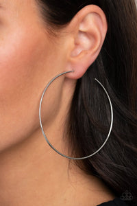 Paparazzi Very Curvaceous - Silver - Earrings  -  Delicately hammered in a subtle shimmer, a glistening silver wire dramatically curves into an oversized hoop for a flawless finish. Earring attaches to a standard post fitting. Hoop measures approximately 2 3/4" in diameter.
