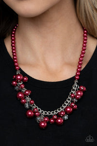 Paparazzi Prim and POLISHED - Red - Necklace  -  Threaded along an invisible wire, a pearly strand of red beads gives way to a section of chunky silver chain below the collar. Clusters of pearly red beads and smoky metallic-flecked crystals swing from the chain, creating a flawless fringe. Features an adjustable clasp closure.
