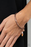 Paparazzi Let Yourself GLOW - Copper - Bracelet  -  A hammered copper bar delicately attaches to a strand of antiqued copper chain adorned in clusters of coppery crystal-like beads. A glowing coppery teardrop crystal swings from the display for a dramatically effortless finish. Features an adjustable clasp closure.
