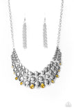 Paparazzi Powerhouse Party - Yellow - Necklace  -  Gradually increasing in size at the center, a shiny collection of antiqued silver ovals join into bubbly plates that interlock below the collar. Dainty round and teardrop yellow rhinestones dot the bottom of the bowing display, adding dramatic hints of sparkle to the powerhouse piece. Features an adjustable clasp closure.
