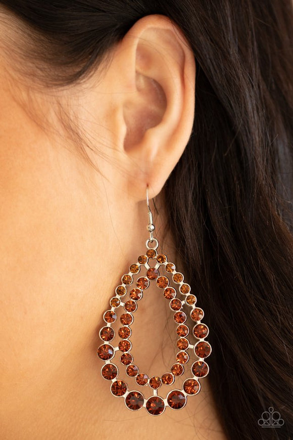 Paparazzi Glacial Glaze - Brown - Earrings  -  Varying in size, rows of glittery topaz rhinestones coalesce into two blinding teardrops for a jaw-dropping dazzle. 
