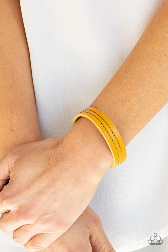 Paparazzi Life is WANDER-ful - Yellow - Bracelet   -  The front of a dainty yellow leather band is stitched in two linear rows, creating a colorfully rustic centerpiece around the wrist. Features an adjustable snap closure.
