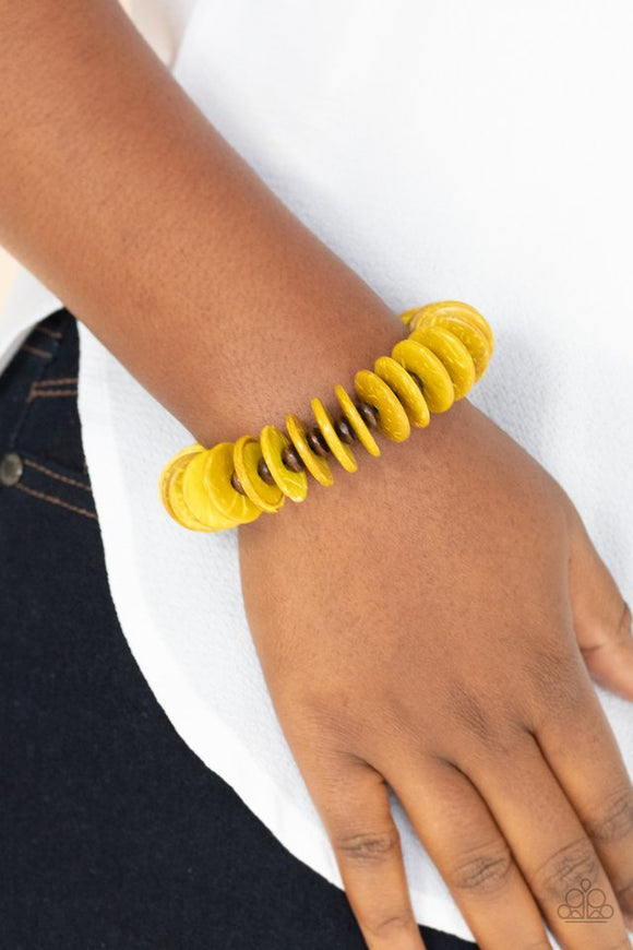Paparazzi Caribbean Reefs - Yellow - Bracelet  -  Yellow wooden beads and distressed yellow wooden discs alternate along a stretchy band around the wrist, creating a colorful pop of summer flavor.
