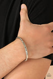 Paparazzi Keep Calm and Believe - Silver - Bracelet  -  Twisted silver bars attach to a shiny silver plate stamped in the word, "BELIEVE," creating an inspiring cuff around the wrist.
