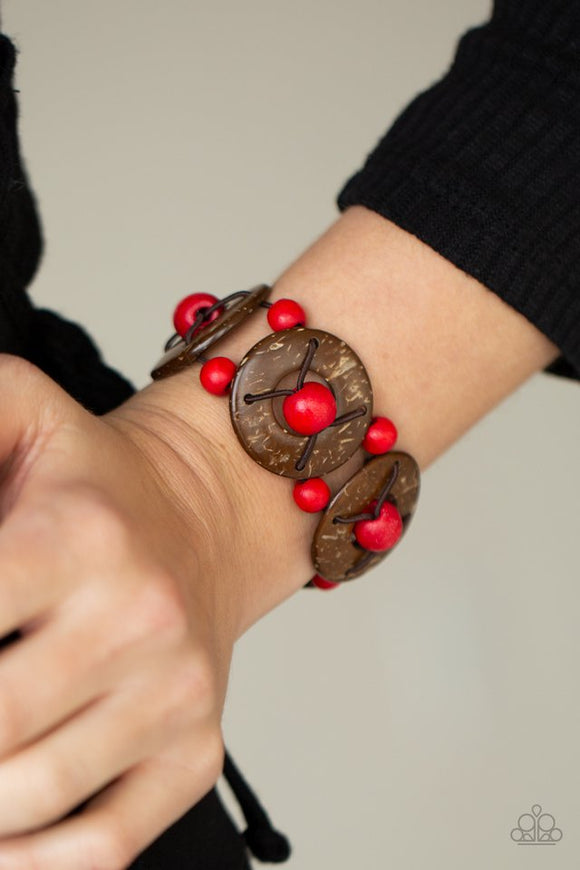 Paparazzi Island Adventure - Red - Bracelet  -  An oversized collection of red wooden beads and distressed brown wooden discs are threaded along stretchy bands that decoratively weave around the wrist for a summery flair.
