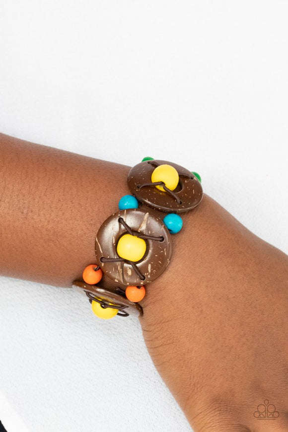 Paparazzi Island Adventure - Multi - Bracelet  -  An oversized collection of multicolored beads and distressed brown wooden discs are threaded along stretchy bands that decoratively weave around the wrist for a summery flair.
