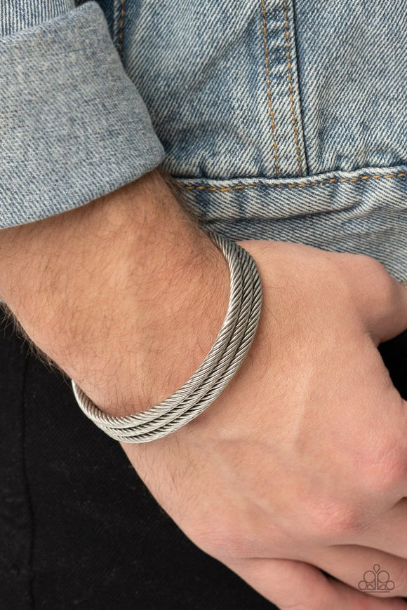 Paparazzi Armored Cable - Silver - Bracelet  -  Three shimmery rows of cable-like bars spin across the front of the wrist, coalescing into an edgy stacked cuff.

