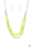 Paparazzi Staycation Status - Green - Necklace  -  Infused with dainty silver cube and round beaded accents, green shell-like beads are threaded along invisible wires below the collar for a summery inspiration. Features an adjustable clasp closure.
