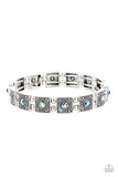 Paparazzi Cosmic Conquest - Blue - Bracelet  -  Dotted with iridescent blue rhinestone centers, studded silver frames alternate with pairs of dainty silver beads along stretchy bands, creating a stellar centerpiece around the wrist.
