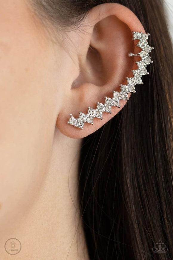 Paparazzi Let There Be LIGHTNING - White - Earrings  -  Encased in studded silver fittings, pairs of glassy white rhinestones stack into a zigzagging frame up the ear for an electrifying fashion. Features a dainty cuff attached to the top for a secure fit.
