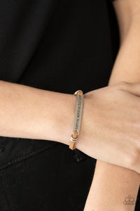 Paparazzi To Live, To Learn, To Love - Brown - Bracelet  -  Infused with pairs of silver rings, a silver plate stamped in the phrase, "To Live, To Learn, To Love," is knotted in place around the wrist by brown suede bands for an inspirational look. Features an adjustable sliding knot closure.
