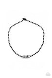 Paparazzi Pull The Ripcord - Black - Set  -  Three bold silver accents slide along a knotted black cord adorned in dainty silver rings, creating an edgy display below the collar. Features a button loop closure.