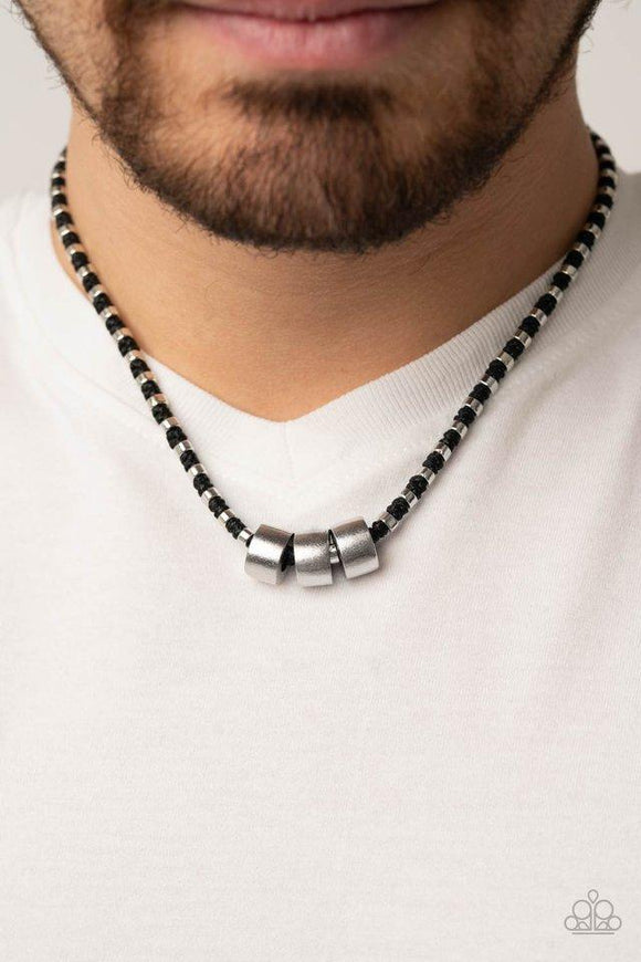 Paparazzi Pull The Ripcord - Black - Set  -  Three bold silver accents slide along a knotted black cord adorned in dainty silver rings, creating an edgy display below the collar. Features a button loop closure.