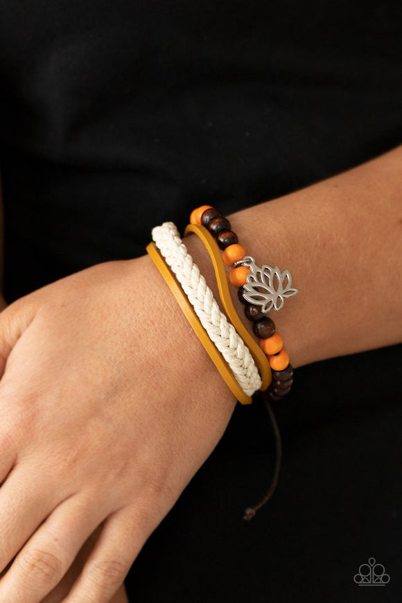 Paparazzi Lotus Beach - Orange - Bracelet  -  Featuring a silver lotus charm, a strand of brown and orange wooden beads, braided white cording, and strands of brown leather layer around the wrist for a seasonal flair. Features an adjustable sliding knot closure.
