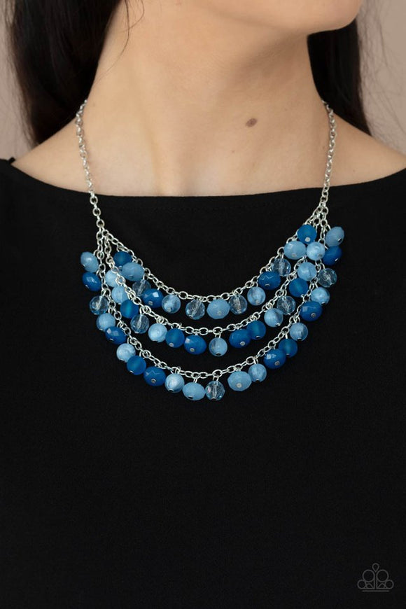 Paparazzi Fairytale Timelessness - Blue - Necklace  -  Varying in shape and opacity, a mismatched collection of blue and Cerulean crystal-like beads drip from the shimmery silver chains, creating an enchanted layered fringe below the collar. Features an adjustable clasp closure.
