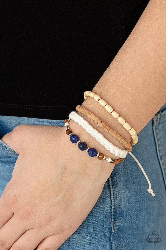 Paparazzi Natural-Born Navigator - Blue - Bracelet  -  Featuring cork, thread, and wood, mismatched metallic accents, glassy blue stones, and wood beads adorn earthy layers around the wrist for a whimsical look. Features an adjustable sliding knot closure.
