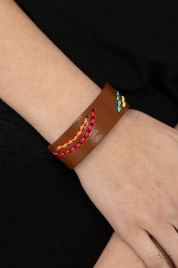 Paparazzi Harmonic Horizons - Multi - Bracelet  -  Multicolored cording is stitched across the front of a brown leather band, creating curved patterns. Features an adjustable snap closure.
