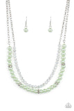 Paparazzi Parisian Princess - Green - Necklace  -  A strand of glassy white crystal-like beads and pearly Green Ash beads and white rhinestone encrusted silver rings layer below the collar, creating a timeless display. Features an adjustable clasp closure.
